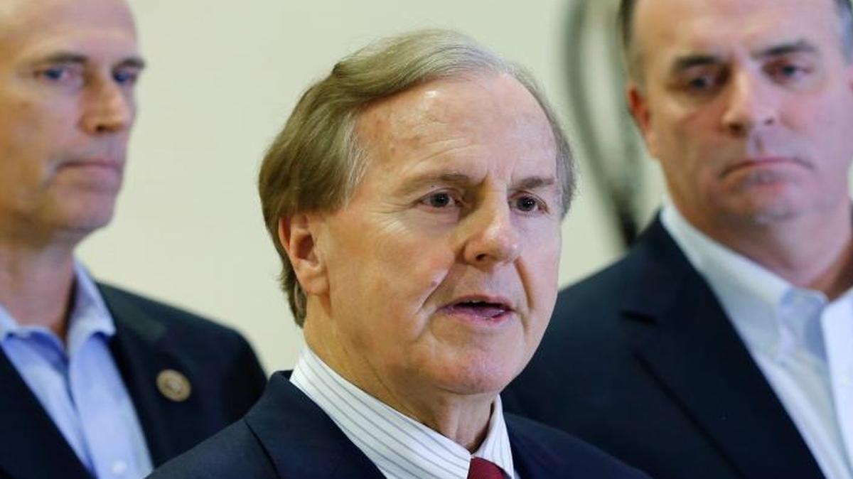 U.S. Representatives Robert Pittenger, center, Dan Kildee, right, and Jared Huffman, left, talk to media people at the Landstuhl Regional Medical Center in Landstuhl, Germany, Jan. 18, 2016.