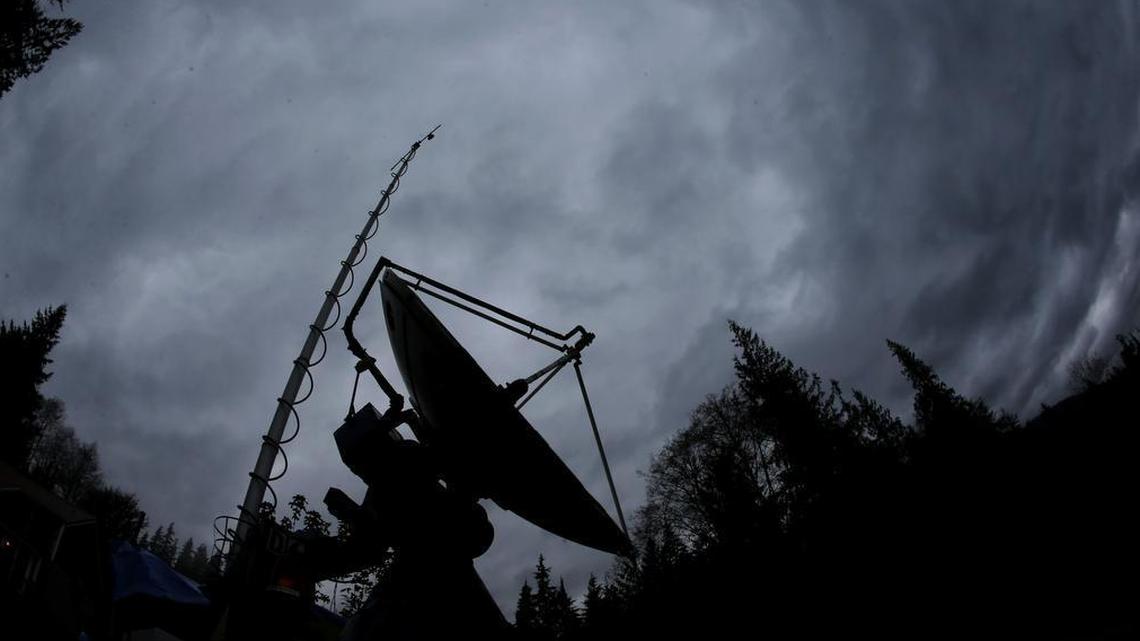 A truck-mounted radar instrument called the Doppler On Wheels is silhouetted against cloudy skies.