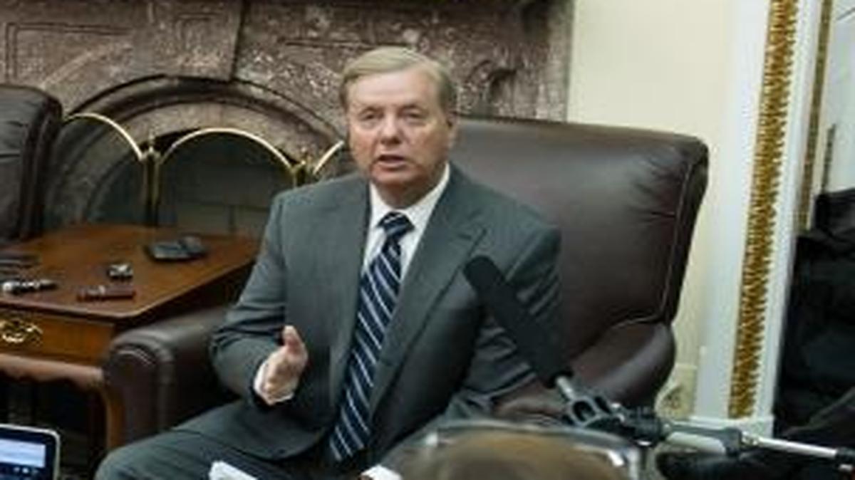 Sen. Lindsey Graham, R-S.C. with reporters in the Senate Press Gallery in Washington.
