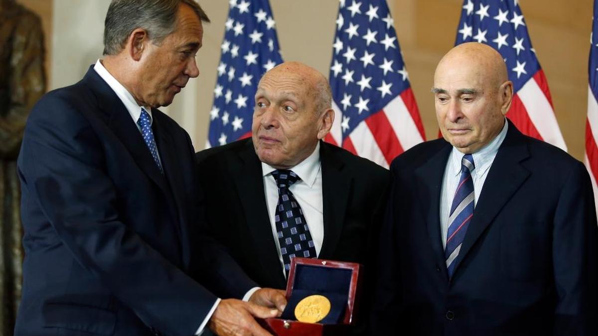 House Speaker John Boehner of Ohio, left, presents the Congressional Gold Medal to Monuments Men Harry Ettlinger, center, and Richard Barancik, Thursday, Oct. 22, 2015, during a ceremony in Emancipation Hall on Capitol Hill in Washington. The award is Congress' highest honor of appreciation for distinguished achievement.