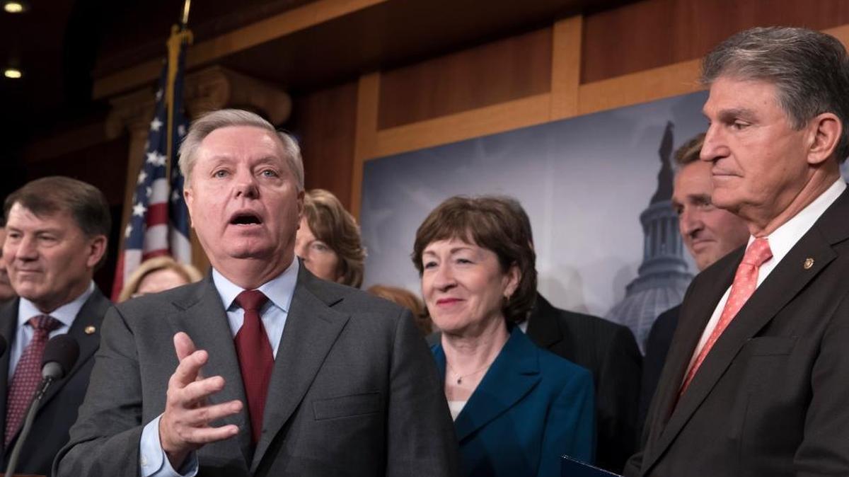 Sen. Lindsey Graham, R-S.C., joined by, from left, Sen. Mike Rounds, R-S.D., Sen. Susan Collins, R-Maine, and Sen. Joe Manchin, D-W.Va., talks Thursday about the immigration deal the senators crafted.