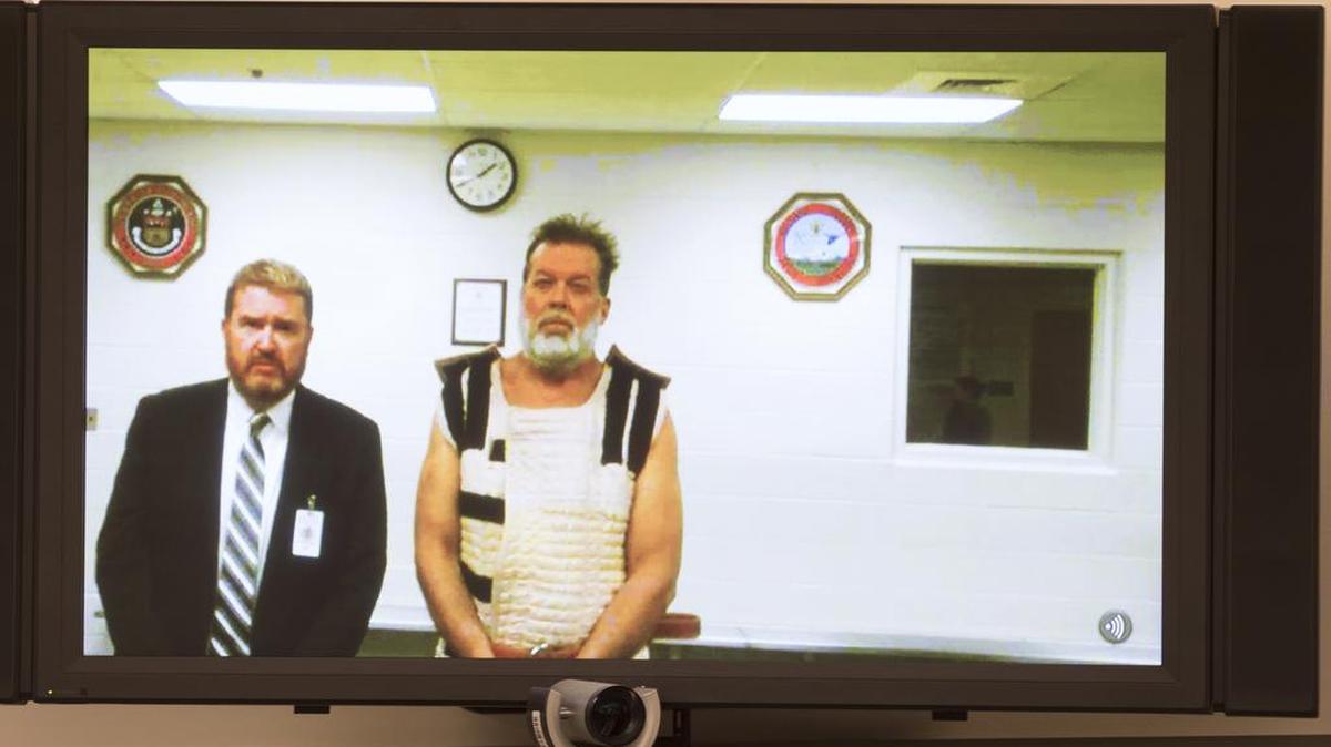 Colorado Springs Planned Parenthood shooting suspect Robert Dear, right, appears via video hearing during his first court appearance, where he was told he faces first degree murder charges, Monday, Nov. 30, 2015, in Colorado Springs, Colo. At left is public defender Dan King.