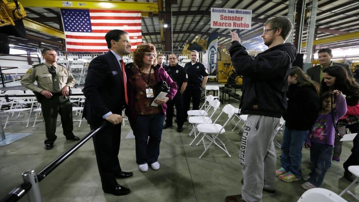 Republican presidential candidate Sen. Marco Rubio, R-Fla., talks with Becca Goemaat as her son David takes a photo at right during a campaign stop at Weiler Manufacturing, Thursday, Dec. 17, 2015, in Knoxville, Iowa.