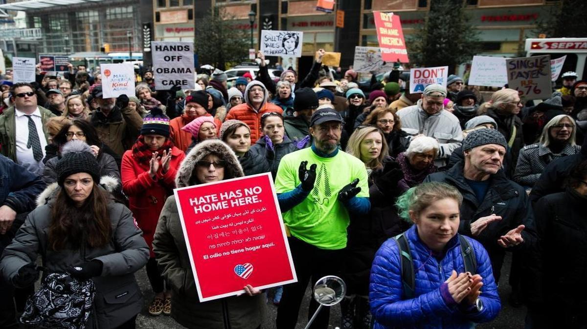Protesters gather outside an office of Sen. Pat Toomey, R-Pa., calling on him to oppose repealing the Affordable Care Act without offering a replacement, in Philadelphia, Tuesday, Jan. 31, 2017.