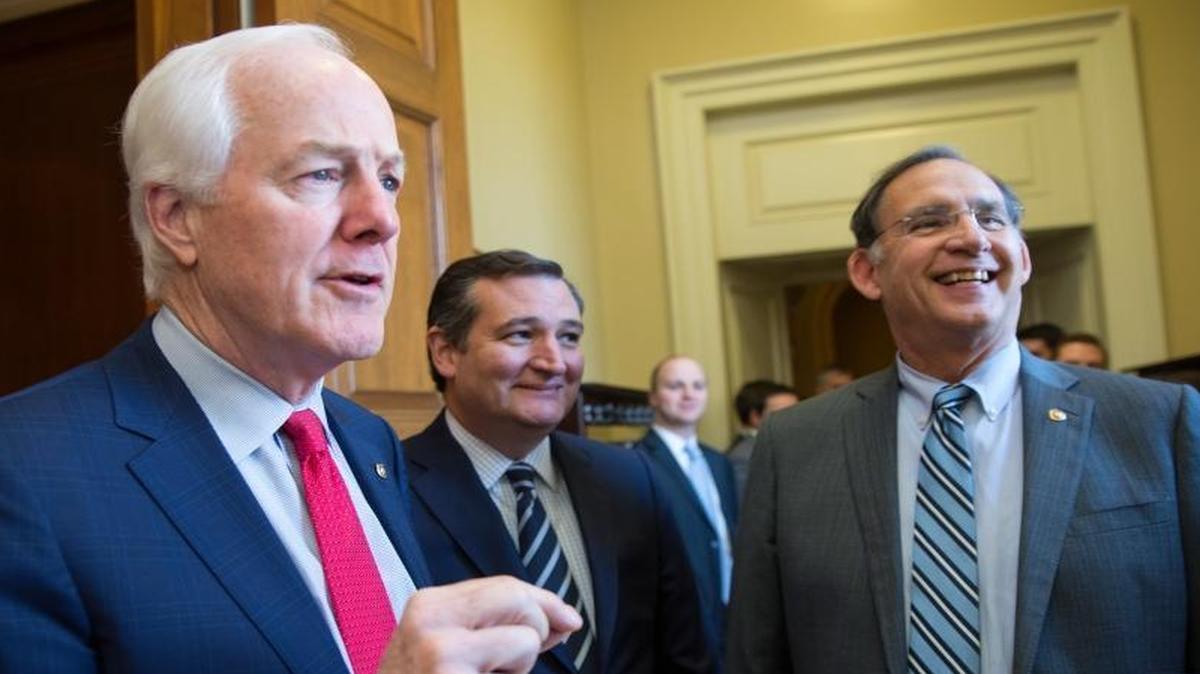 Senators John Cornyn, R-Texas, Ted Cruz, R-Texas, and John Boozman, R-Ark., left to right, crack jokes about the upcoming competition between cheeses at the Capitol Building in Washington, D.C., on Dec. 7, 2016. A blind-tasting contest was held at the Capitol Building today among senators to determine which had the better taste: Arkansas Cheese Dip or Texas Queso.