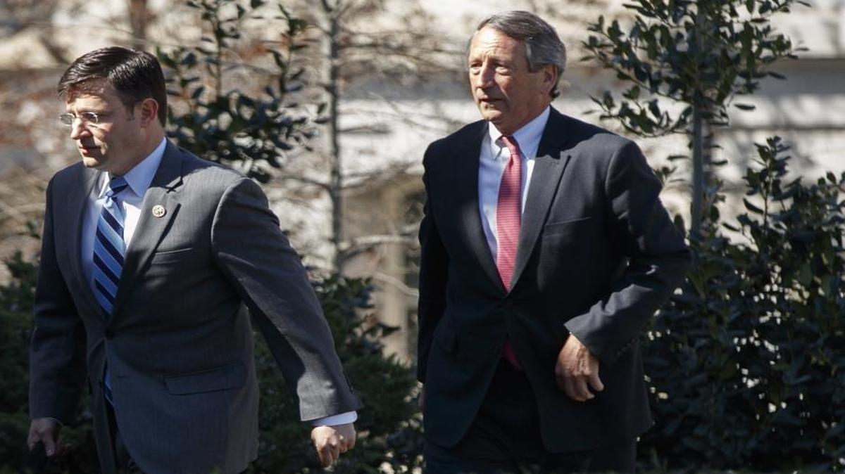 Members of the House Freedom Caucus Reps. Justin Amash, R-Mich., left, and Mark Sanford, R-S.C., arrive at the White House in Washington, Thursday, March 23, 2017.