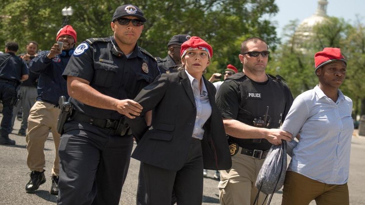 RachelRamone Donlan, left, and Collette Cobb are arrested after handing out joints during the 1st Annual Congressional #JointSession pot giveaway to credentialed Capitol Hill staff and the media on Constitution Avenue and First Street Northeast, on Thursday, April 20, 2017. The event was held by the group DCMJ to call on Congress to reauthorize an amendment that prevents federal legal intervention in the District's marijuana laws.