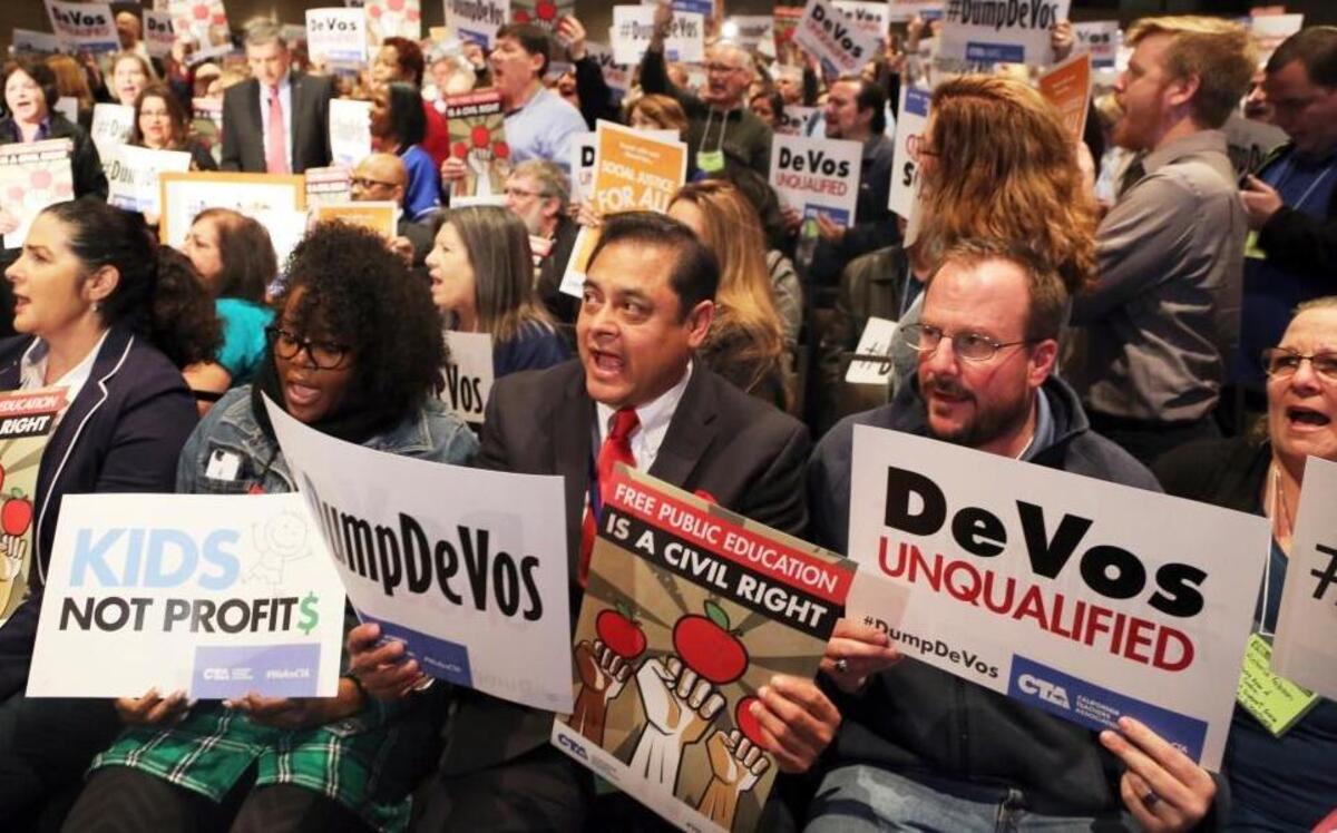 Sergio Martinez, center, a teacher at Sparks Elementary School in La Puente, Calif., joins hundreds of others as California educators voice their opposition to President Donald Trump's nomination of Besty DeVos as Secretary of Education, at a California Teachers Association meeting in Los Angeles on Jan. 28, 2017.