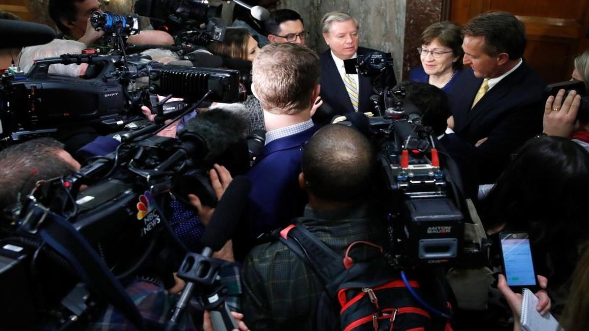 Sen. Lindsey Graham, R-S.C., back left, Sen. Susan Collins, R-Maine, and Sen. Jeff Flake, R-Ariz., speak to the media after attending a bipartisan meeting of senators.