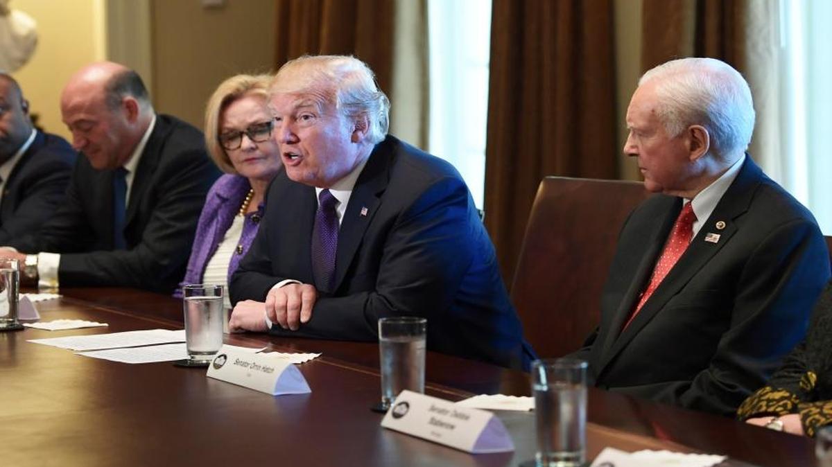 President Donald Trump, center, speaks during a meeting with members of the Senate Finance Committee and members of the President's economic team in the Cabinet Room of the White House in Washington, Wednesday, Oct. 18, 2017. Trump is joined by, from left, Sen. Tim Scott, R-S.C., White House chief economic director Gary Cohn, Sen. Claire McCaskill, D-Mo., and Senate Finance Committee Chairman Sen. Orrin Hatch, R-Utah.