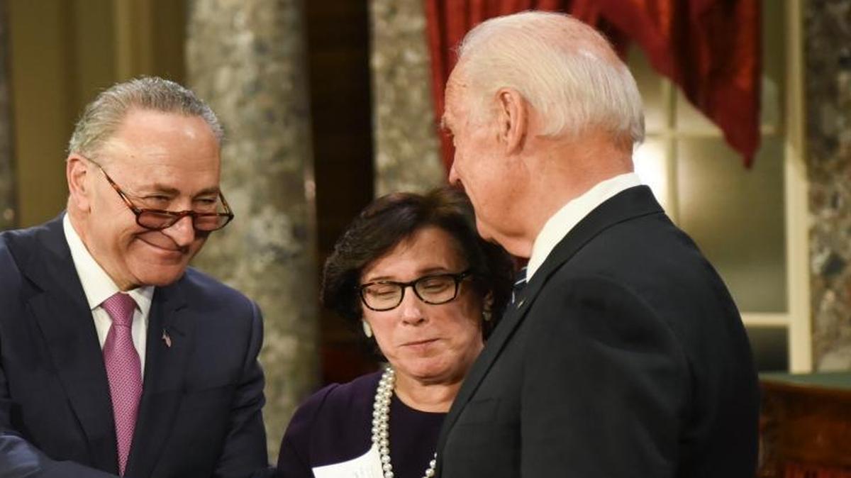 Vice President Joe Biden shakes hands with Senate Minority Leader Sen. Chuck Schumer, D-N.Y., accompanied by Schumer’s wife, Iris Weinshall, during a a mock swearing-in ceremony. Schumer will lead an effort to dilute Republican efforts to repeal Obamacare.
