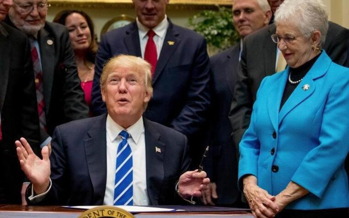 House education committee Chair Virginia Foxx, R-N.C., stands to the right of President Donald Trump on March 27, 2017, as he signs a law repealing Obama administration regulations on K-12 education. Also pictured, from left, Rep. Liz Cheney, R-Wyo., Sen. John Barrasso, R-Wyo., Rep. Don Young, R-Alaska, Lolita Zinke, her husband, Interior Secretary Ryan Zinke, Vice President Mike Pence and Sen. Ron Johnson, R-Wis.