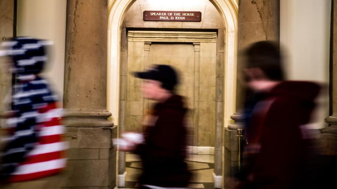 FILE – Tourists walk by House Speaker Paul Ryan's office. Two Republican lawmakers are hoping to change a federal law that allows former House speakers certain taxpayer-funded perks after leaving office.