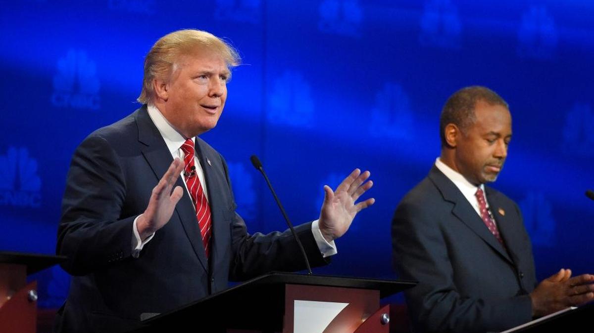 Donald Trump, left, speaks as Ben Carson looks on during the CNBC Republican presidential debate at the University of Colorado, Wednesday, Oct. 28, 2015, in Boulder, Colo. He’s scheduled to share the stage with the cast of NBC’s “Saturday Night Live” this weekend.