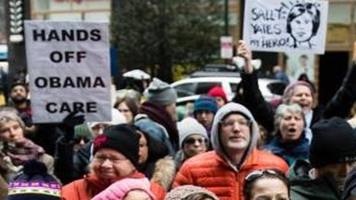 Protesters gather outside an office of Sen. Pat Toomey, R-Pa., calling on him to oppose the repeal of the Affordable Care Act without offering a replacement, in Philadelphia, Tuesday, Jan. 31, 2017.