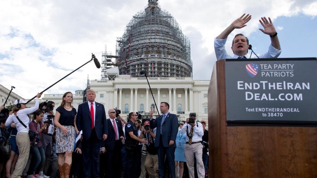 
Republican presidential candidate Donald Trump stands left with Jenny Beth Martin, president and co-founder of the Tea Party Patriots, as Republican presidential candidate Sen. Ted Cruz, R-Texas, speaks during a rally organized by Tea Party Patriots in on Capitol Hill in Washington, Wednesday, Sept. 9, 2015, to oppose the Iran nuclear agreement. 
