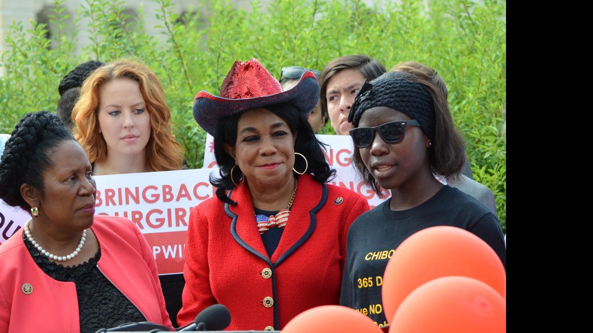 
U.S. Reps. Sheila Jackson Lee, D-Texas, (left) and Frederica Wilson, D-Fla., listen to Lilly Pogu, a Nigerian girl who escaped from the Boko Haram group last year and is now living in Virginia. She spoke at an event outside the U.S. Capitol July 21, 2015, to help put pressure on the new Nigerian president to work to release girls still in captivity.
