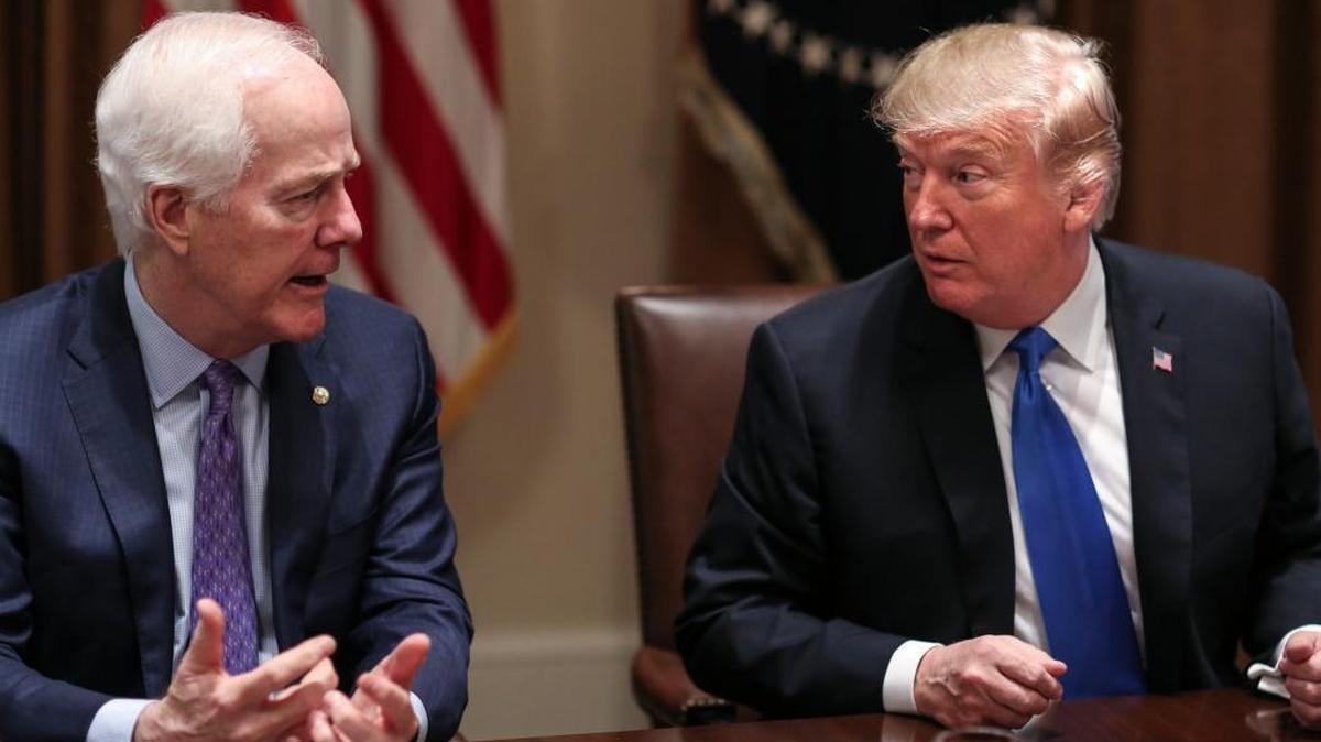 President Donald Trump, right, listens as Senator John Cornyn (R-Texas) speaks during a meeting with bipartisan members of Congress on school and community safety in the Cabinet Room of the White House on Wednesday, Feb. 28, 2018, in Washington, D.C.