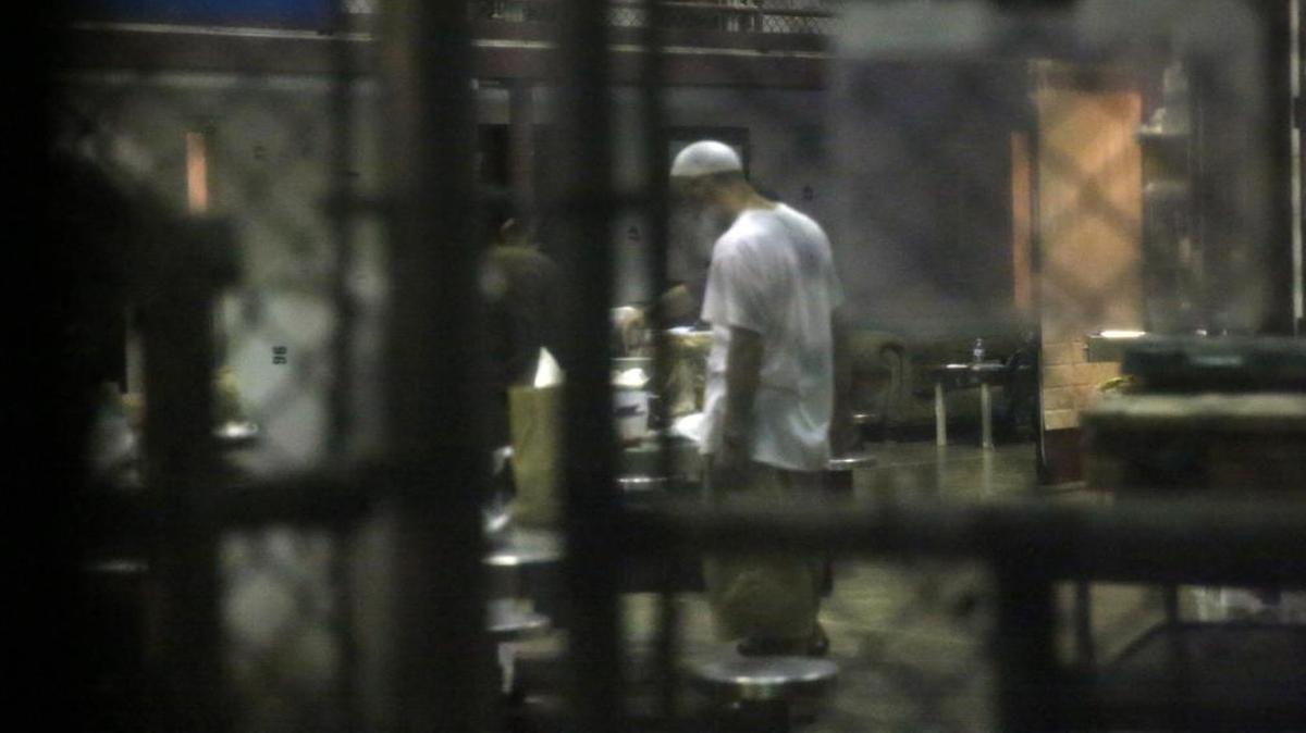 A detainee stands in the common area of the cell block on Saturday morning, Feb. 11, 2017, at Camp 6 at Guantánamo’s Detention Center Zone. The military approved release of this photo.