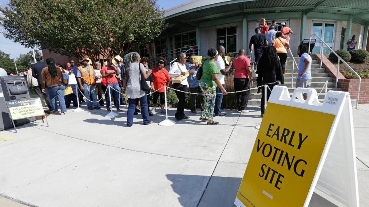 Voters line up during early voting at Chavis Community Center in Raleigh, N.C.