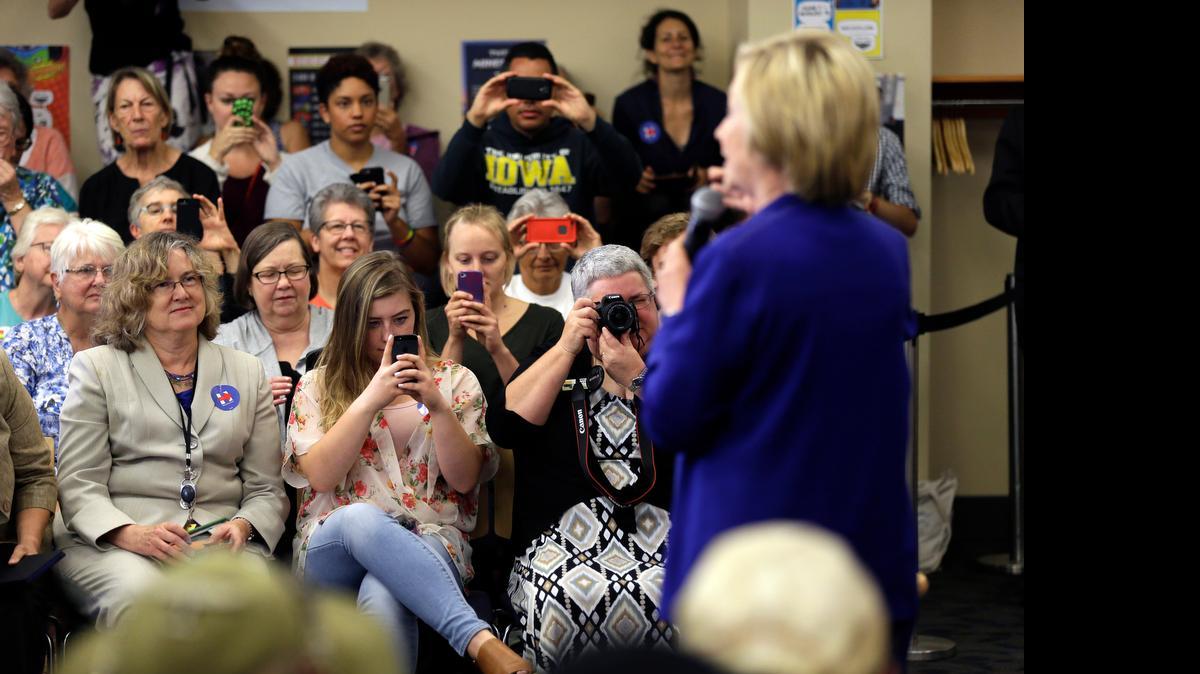
Supporters take pictures as Democratic presidential candidate Hillary Rodham Clinton speaks to local residents during a campaign stop at the Iowa City Public Library, Tuesday, July 7, 2015, in Iowa City, Iowa. 
