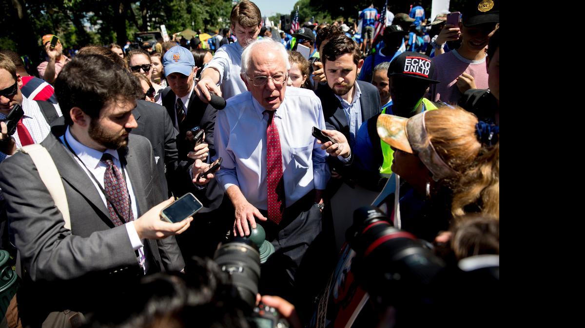 
Democratic presidential candidate Sen. Bernie Sanders speaks to reporters after addressing federal contract workers at a rally on Capitol Hill in Washington Wednesday. Sanders same under fire from black activists this weekend.
