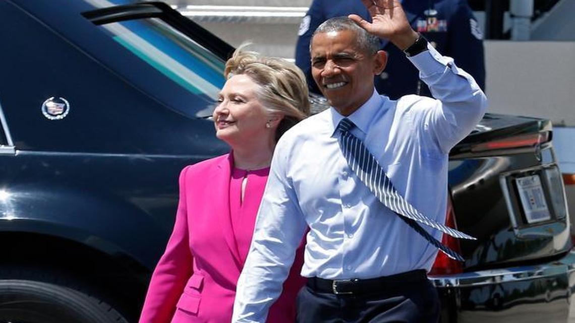 Democratic presidential candidate Hillary Clinton and President Barack Obama make their way across the tarmac to greet guests during a visit to Charlotte, N.C., on Tuesday, July 5, 2016, after FBI Director James Comey said his agency would recommend that she not be charged in connection with her use of a private email server while secretary of state.