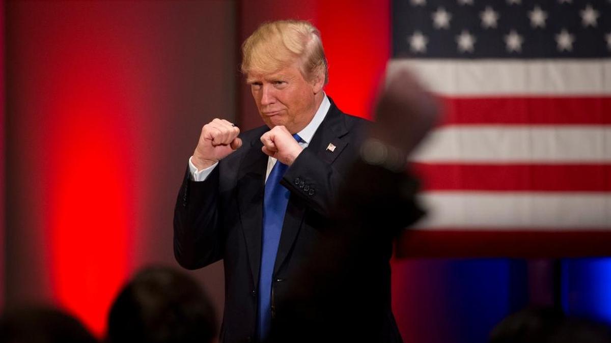 Republican presidential candidate Donald Trump poses with a ring given to him by a group of veterans during a campaign event on the campus of Drake University on Thursday, Jan. 28, 2016, in Des Moines, Iowa.