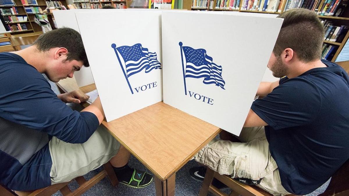 Spotswood High School seniors Jared Morris, left, and Nathan Rebich vote in a mock election in Penn Laird, Va., on Tuesday, Sept. 13, 2016.