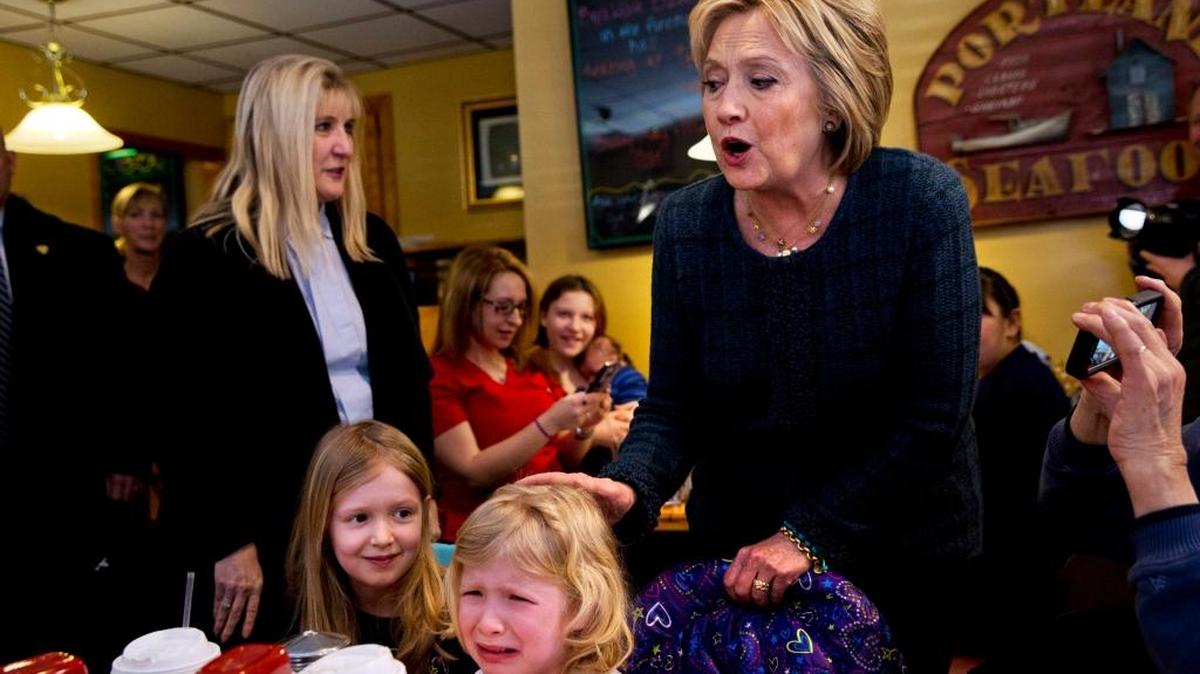 Ella Hamel, 4, of Concord, N.H., cries as she and her sister Ava Hamel, 7, are greeted by Democratic presidential candidate Hillary Clinton during a campaign stop at Belmont Hall in Manchester Saturday.