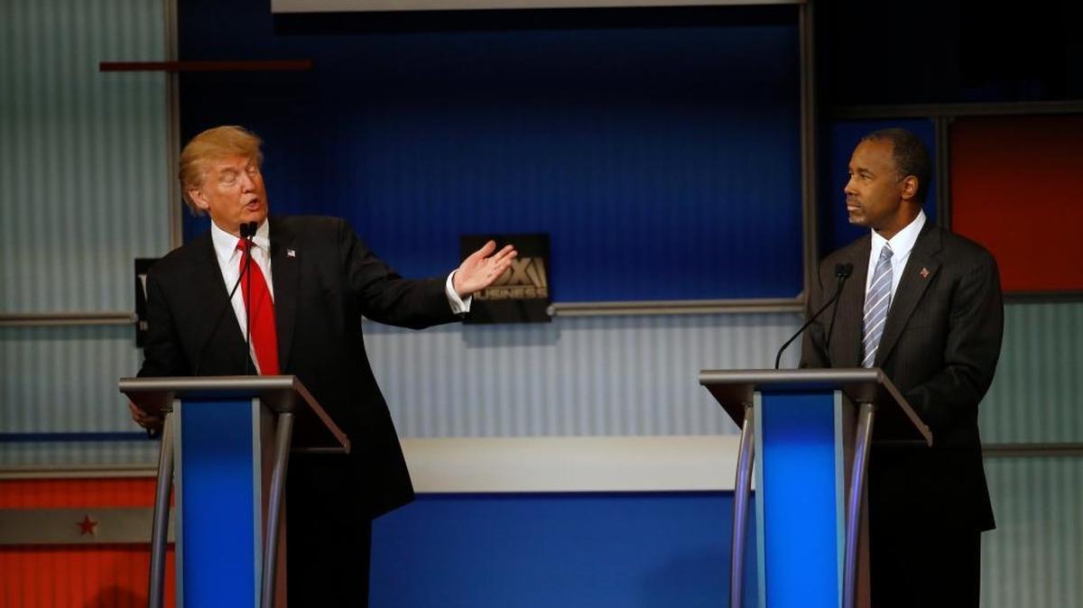 Donald Trump speaks as Ben Carson listens during the Republican presidential debate at the Milwaukee Theatre, Wednesday, Nov. 11, 2015, in Milwaukee. Both candidates have criticized the handling of protests at the University of Missouri and Yale University while Democratic candidates Bernie Sanders and Hillary Clinton expressed support for students.