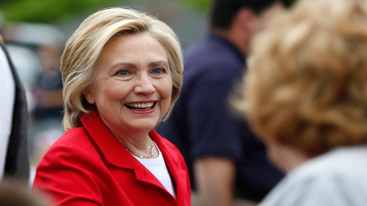 
Democratic presidential candidate Hillary Rodham Clinton greets a spectator at a Fourth of July parade, Saturday, July 4, 2015, in Gorham, N.H.
