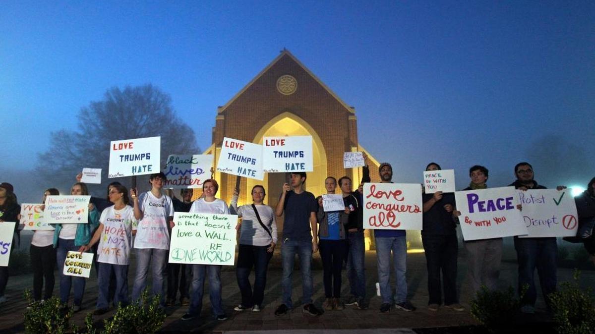 Protesters wait before dawn outside a church at Lenoir-Rhyne University before a rally for Republican presidential candidate Donald Trump in Hickory, N.C., Monday.