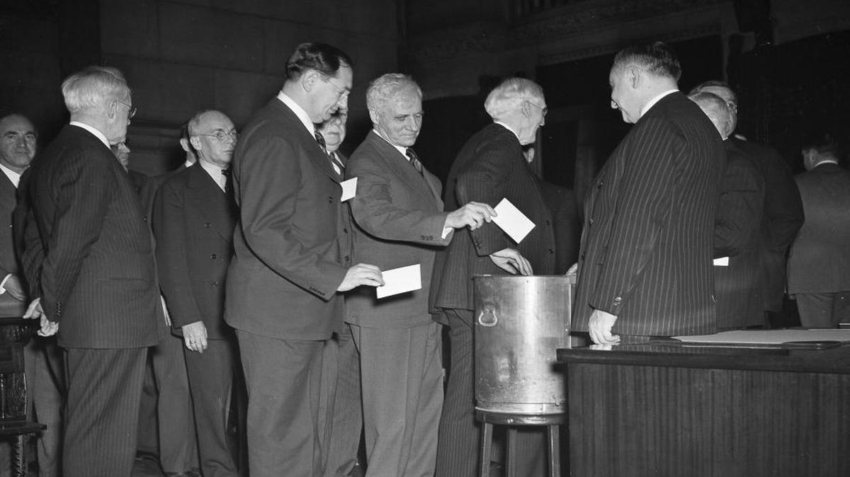 In this Dec. 16, 1940 file photo, New York State electoral college members cast votes at the state capital in Albany, N.Y. Most people who voted early or are heading to the polls on Nov. 8, 2016 think they will be voting for Democrat Hillary Clinton, Republican Donald Trump or their chosen third-party candidate. But they won't be. They'll be voting for their state's electors, who will in turn cast votes for the presidential candidate who wins the most votes in their state.