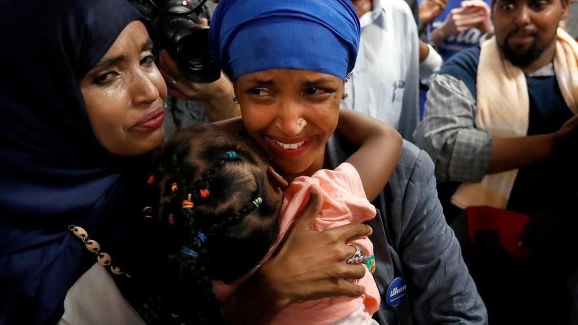 Somali activist Ilhan Omar, center, is greeted by supporters at Kalsan Tuesday, Aug. 9, 2016, in Minneapolis.