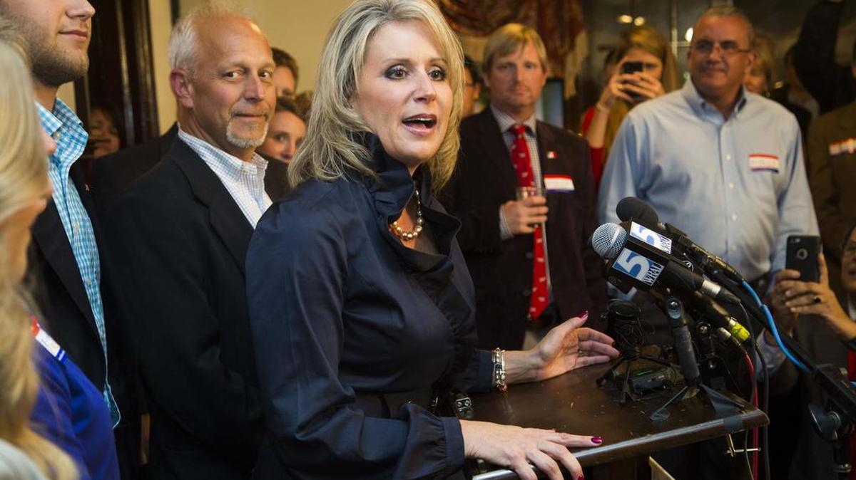 Republican U.S. Rep. Renee Ellmers speaks to supporters after winning re-election in 2014. Her husband, Brent Ellmers, is pictured over her left shoulder.
