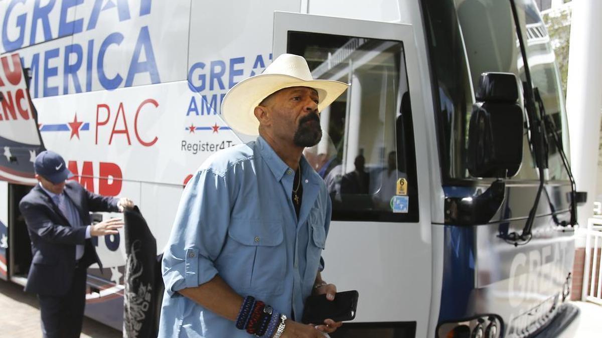 In this Monday, Sept. 12, 2016, photo, David A. Clarke Jr., Sheriff of Milwaukee County, Wis., and Donald Trump supporter, arrives on the Great America PAC bus for a town hall meeting in Lake Mary, Fla.