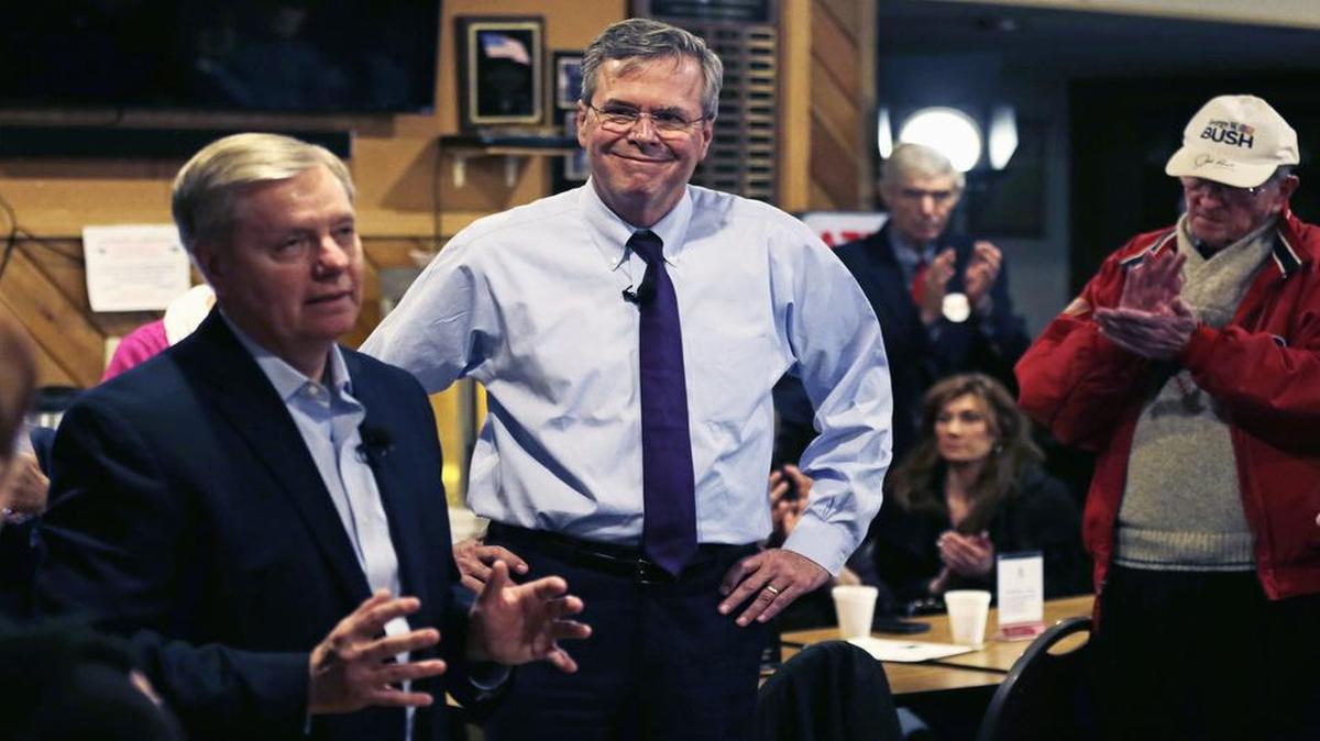 Former Florida Gov. Jeb Bush listens as Sen. Lindsey Graham, R-S.C., speaks during a campaign stop at an American Legion post in Manchester, N.H., on Wednesday, Jan. 20, 2016.