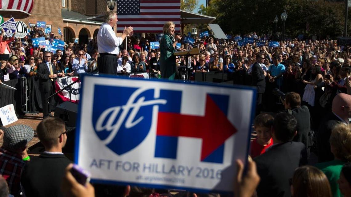 Democratic presidential candidate Hillary Clinton, accompanied by Virginia Gov. Terry McAuliffe, speaks during a campaign rally, Friday, Oct. 23, 2015, in Alexandria, Va.