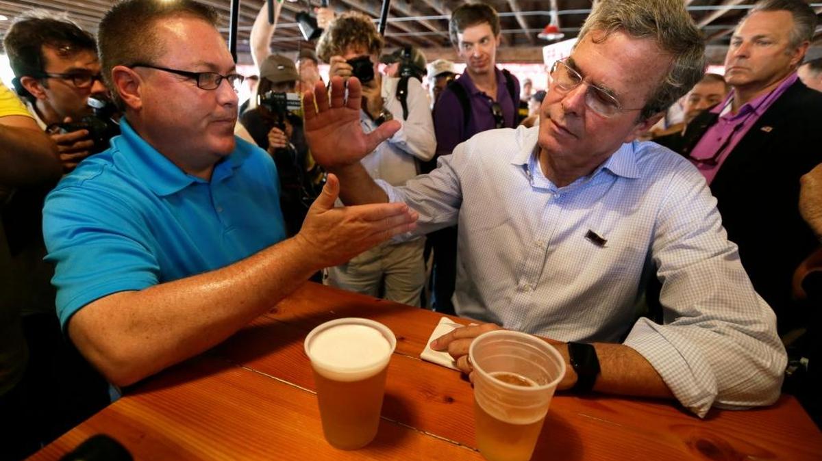 
Republican presidential candidate former Florida Gov. Jeb Bush talks with Chris McLinden of Waukee, Iowa, during a visit to the Iowa State Fair, Friday, Aug. 14, 2015, in Des Moines, Iowa. 
