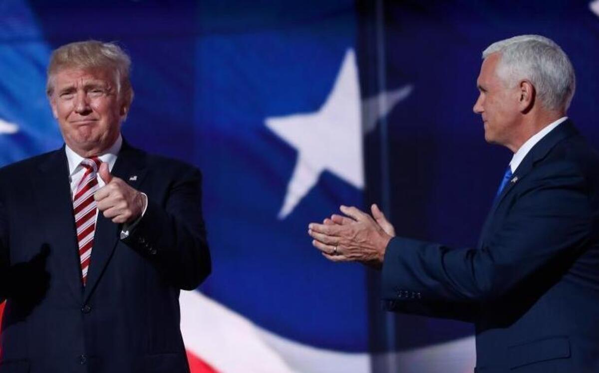 Republican Presidential Candidate Donald Trump, left, gestures as he stands with his running mate, Republican Vice Presidential Nominee Gov. Mike Pence of Indiana after Pence's acceptance speech during the third day session of the Republican National Convention in Cleveland, Wednesday, July 20, 2016.