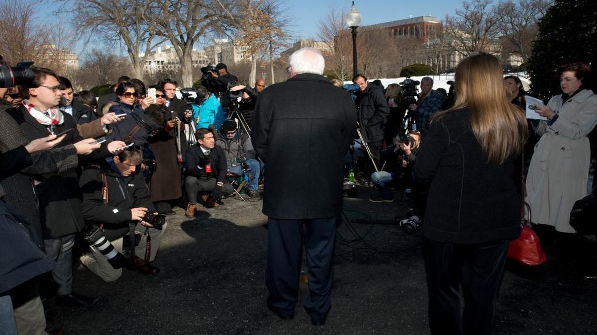 Sen. Bernie Sanders, joined by his wife, Jane Sanders, right with long hair, talks to the media outside the West Wing of the White House in Washington on Wednesday, Jan. 27, 2016, after meeting with President Barack Obama.