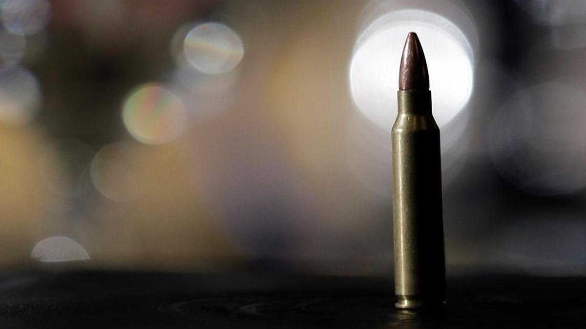 A bullet sits in front of Springettsbury, Pa., Police Chief Thomas Hyers at Girard College in Philadelphia, Feb. 11, 2013.