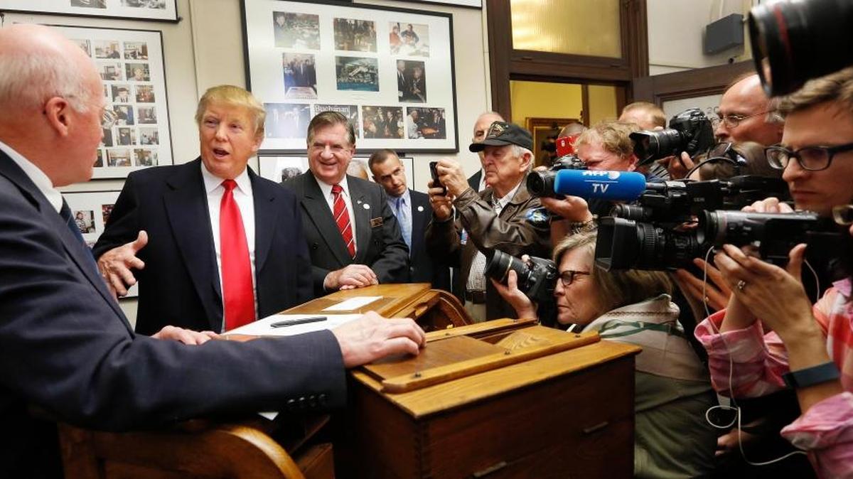 Republican presidential candidate Donald Trump talks with New Hampshire Secretary of State Bill Gardner before filing papers to be on the nation's earliest presidential primary ballot, Wednesday, Nov. 4, 2015, at The Secretary of State's office in Concord, N.H.