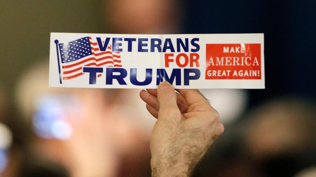 A supporter holds a sign during a primary night rally for Republican presidential candidate Donald Trump on Tuesday, Feb. 9, 2016, in Manchester, New Hampshire.