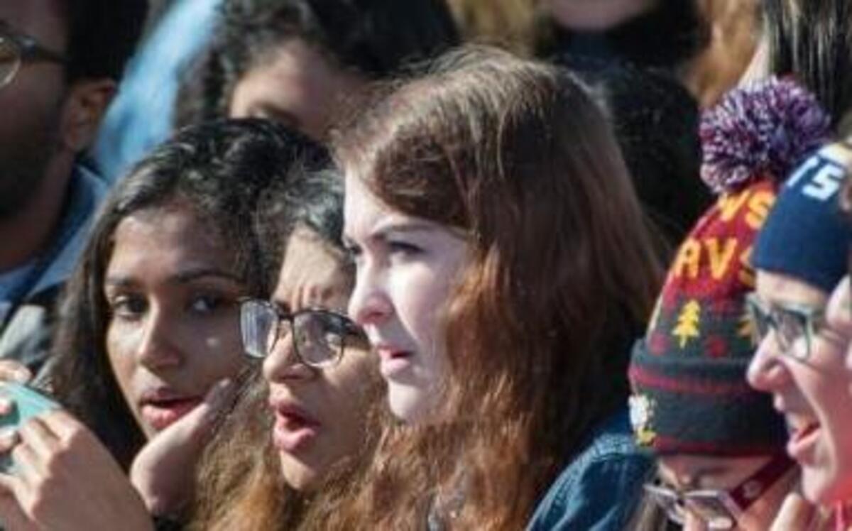 Students sing along to music as they wait for President Barack Obama to speak at a campaign rally for Democratic presidential candidate Hillary Clinton, Friday, Oct. 14, 2016, at the Cleveland Burke Lakefront Airport in Cleveland, Ohio.