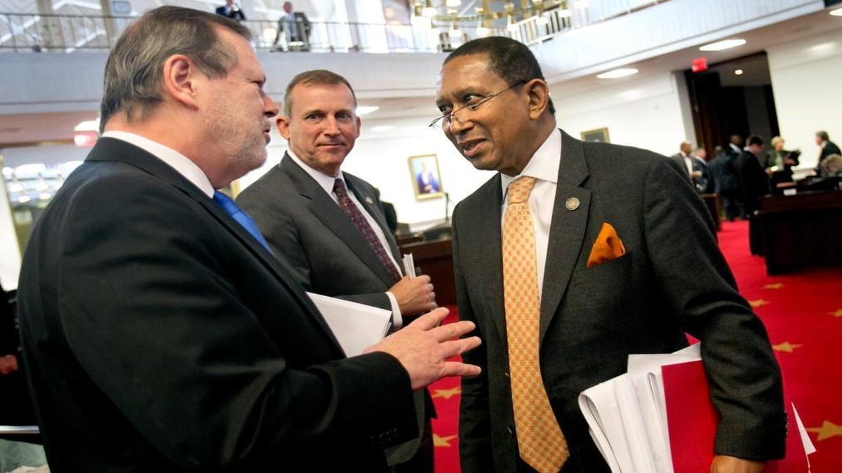 Republican Senators President Pro Tempore Phil Berger, left, and Majority Leader Harry Brown, center, congratulate Floyd McKissick, Jr. (Dem), right, on a good debate after the Senate approved a new redistricting map on Tuesday, February 16, 2016 at the N.C. General Assembly. The Republicans approved the map with a vote of 32-15.