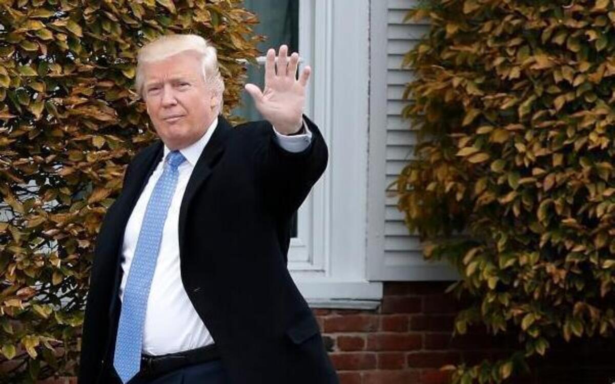FILE - In this Nov. 20, 2016 file photo, President-elect Donald Trump waves as he arrives at the Trump National Golf Club Bedminster clubhouse in Bedminster, N.J. Thousands of high school students from Seattle to Silver Spring, Md., have taken to the streets since Trump's election to protest his proposed crackdown on illegal immigration and his rude comments about women.