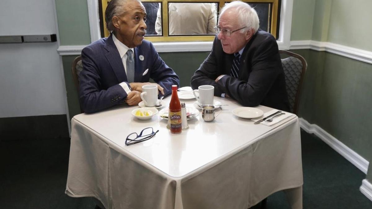 The Rev. Al Sharpton talks with Democratic presidential candidate Sen. Bernie Sanders, I-Vt. as they sit down for a breakfast meeting at Sylvia's Restaurant, Wednesday, Feb. 10, 2016, in the Harlem neighborhood of New York. Sanders defeated former Secretary of State Hillary Clinton on Tuesday in the New Hampshire primary.