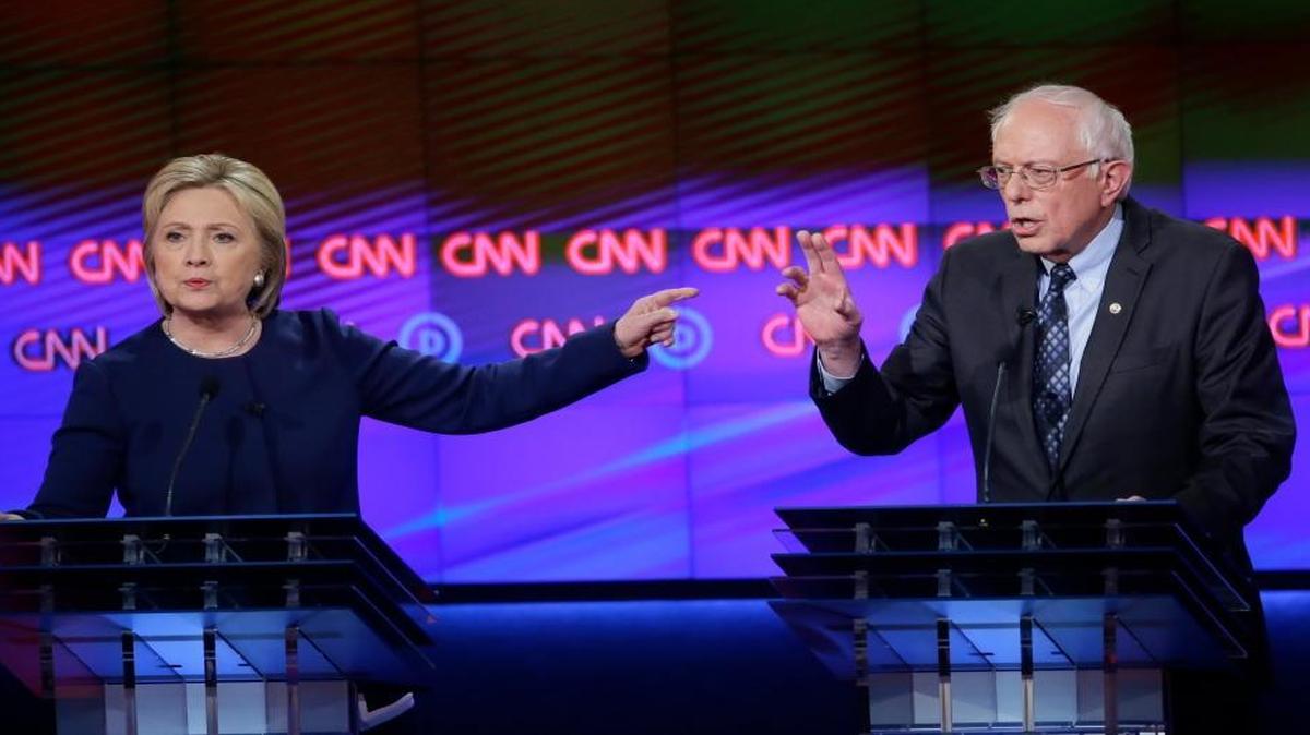 Democratic presidential candidates Hillary Clinton, left, and, Sen. Bernie Sanders, I-Vt., argue a point during a Democratic presidential primary debate at the University of Michigan-Flint, Sunday, March 6, 2016, in Flint, Mich.